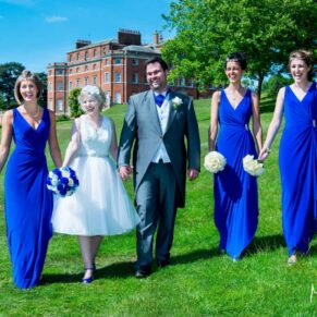 Brocket Hall wedding photographs of the bridal party strolling towards the camera