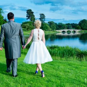Brocket Hall wedding photographs of the newlyweds taking a stroll by the lake