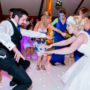 Brocket Hall wedding photographs of the bride loving the wild partying on the dancefloor in the Oak Room