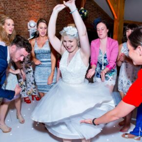 Brocket Hall wedding photographs of the bride loving the partying on the dancefloor in the Oak Room