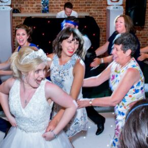 Brocket Hall wedding photographs of the conga in progress on the dancefloor in the Oak Room