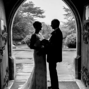 St. Mary's Church Chesham wedding photography of the newlyweds posing for a silhouette shot in the arched doorway