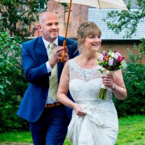 St. Mary's Church Chesham wedding shot of the bride arriving in the rain