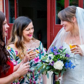 Five Arrows Hotel Waddesdon wedding photography of the bride chatting to two ladies