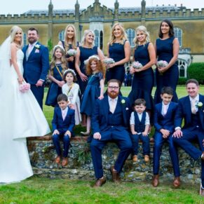 Summer's day wedding at Missenden Abbey - group pose on the haha