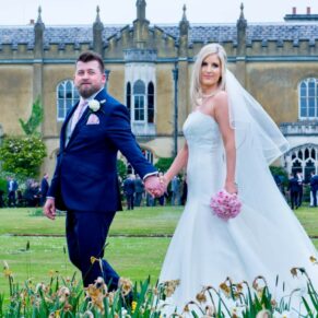 Summer's day wedding at Missenden Abbey - the newlyweds take a stroll beside the flower borders