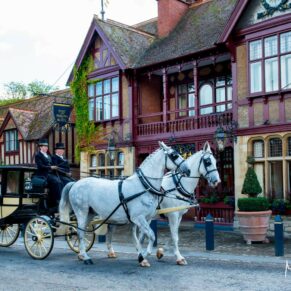 Dairy Waddesdon wedding photos of the horses and carriage passing by the Five Arrows Hotel