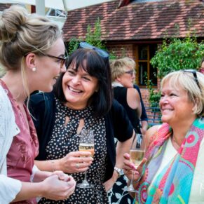 Dairy Waddesdon summer wedding guests chatting in the courtyard