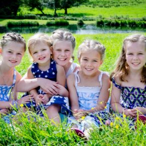 Fun Buckinghamshire outdoor family portraits - children strike a pose in an Amersham hilltop meadow scene