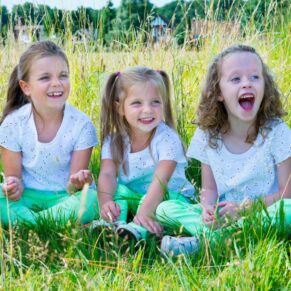 Fun Buckinghamshire outdoor family portraits - children posing for the camera in an Amersham meadow scene