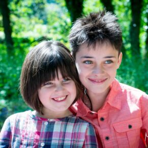 Buckinghamshire outdoor family portraits - children posing for the camera in an Amersham woodland scene on a sunny day