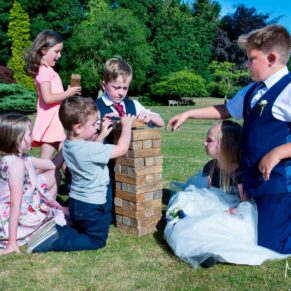 Missenden Abbey wedding images of kids paying Jenga on the lawns