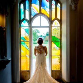 Missenden Abbey wedding celebration - the bride in the stained glass window
