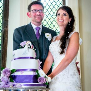 Clearwell Castle wedding shot of the bride and groom cutting the cake
