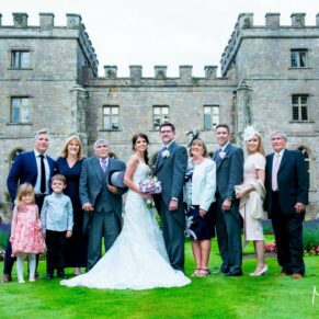 Clearwell Castle wedding group pose in front of the building
