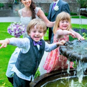 Fun Clearwell Castle wedding image of the children soaking the photographer