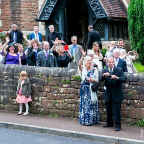 Clearwell Castle - St. Peter's Church wedding photography of the guests outside the building