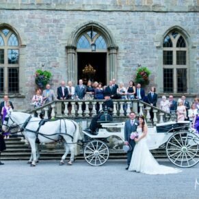Clearwell Castle wedding image of the newlyweds with their guests on the front steps