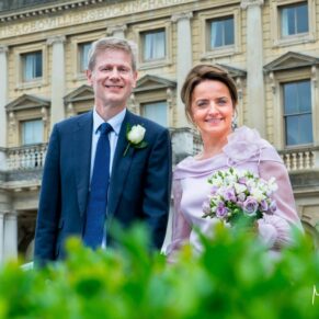Bride and groom walking along at their Cliveden House wedding