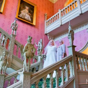 The bride on the staircase with her mother on her Hartwell House autumn wedding day