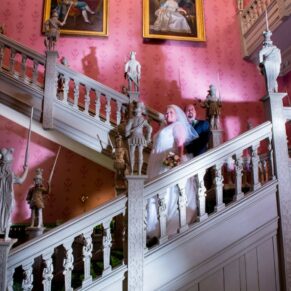 Hartwell House autumn wedding image of the newlyweds on the Jacobean staircase after dusk