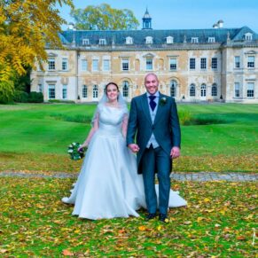 Hartwell House wedding photography of the newlyweds taking a stroll through the autumn leaves