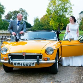 Hartwell House wedding photography of the bride and groom with their lovely vintage car