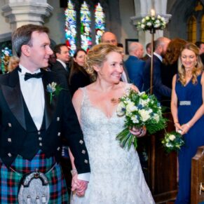 The bride and groom leave the ceremony at St. John The Baptist Church in Great Gaddesdon