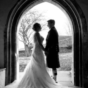 Silhouette shot of the newlyweds at St. John The Baptist Church in Great Gaddesdon