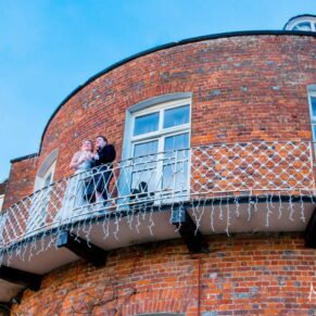 Photography of the bride and groom on the balcony at St Michaels Manor wedding venue in St.Albans