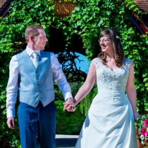 The newlweds take a stroll on their Dairy Waddesdon wedding day