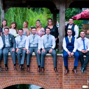 Some of the wedding guests pose on the pavilion for this group pose at this Dairy Waddesdon Manor wedding
