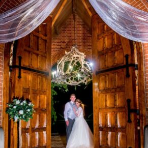 Dairy Waddesdon Manor wedding through the centrance doors at dusk