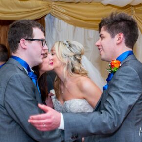 Groom chatting with guests at Notley Tythe Barn wedding