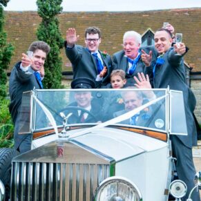 Vintage car and ushers at Notley Tythe Barn wedding