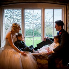 Bride and groom in window at Notley Tythe Barn wedding