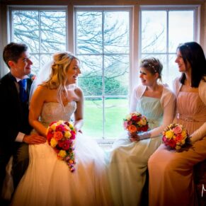 Guests chatting in window at Notley Tythe Barn wedding