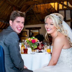 Bride and groom at head table at Notley Tythe Barn wedding