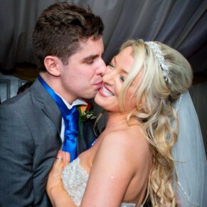 Bride and groom kissing at Notley Tythe Barn wedding