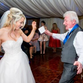 Bride dancing at Notley Tythe Barn wedding