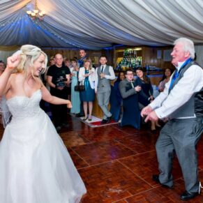 Bride dancing with guests at Notley Tythe Barn wedding