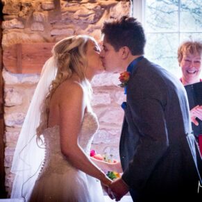 Bride and groom kissing at Notley Tythe Barn wedding