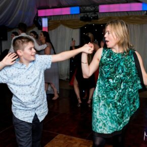 Guests dancing at Notley Tythe Barn wedding