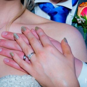 Bride and groom hands with rings at Notley Tythe Barn wedding