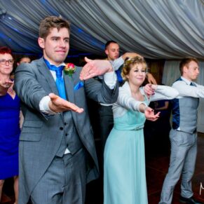 Guests and bridesmaids dancing at Notley Tythe Barn wedding