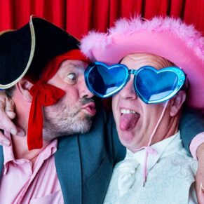 Oakley Court wedding photography in the photo-booth of two lively guests all dressed up