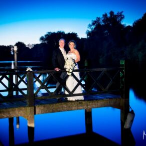 Oakley Court wedding photography of the bride and groom at dusk on the jetty