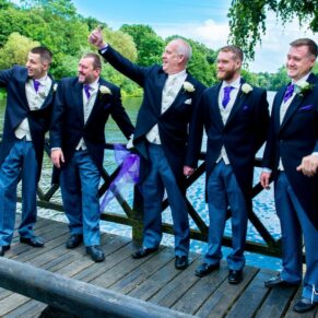 Oakley Court wedding photography of the lads waving to the passing motor boats on the river