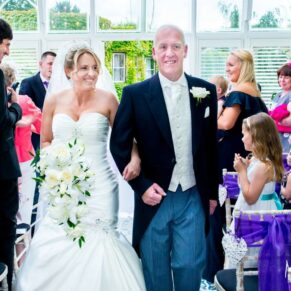 Oakley Court wedding photography of the newlyweds leaving the ceremony