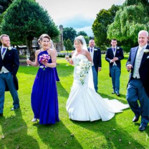 Oakley Court wedding photography of the bridal party walking in the hotel grounds